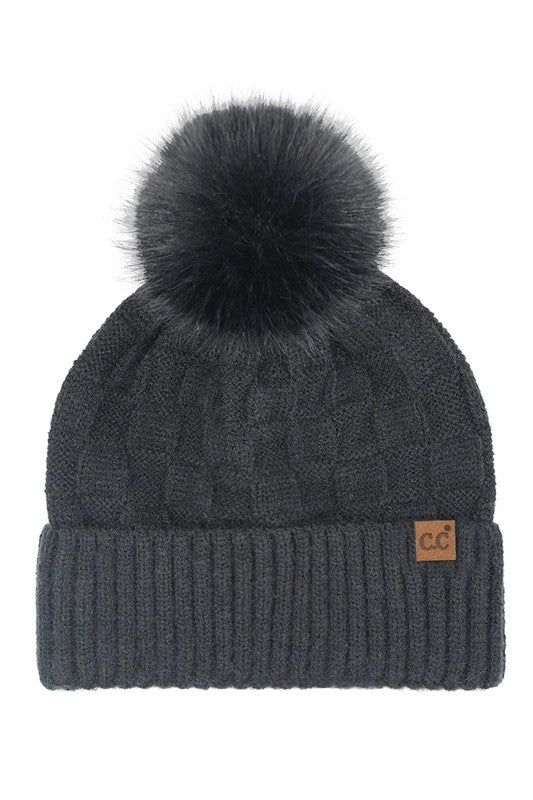 Dark gray knit beanie with a black pom-pom on a white background