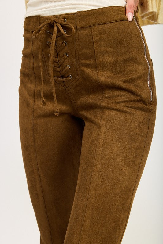 Brown suede pants with lace-up front on a white background
