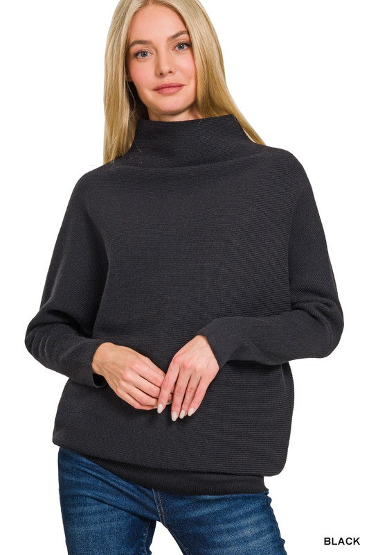 Woman wearing a black sweater with a high neckline on a white background