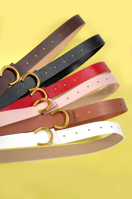 Set of belts with gold buckle on a yellow background