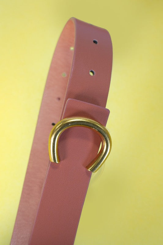 Pink belt with a gold buckle on a yellow background