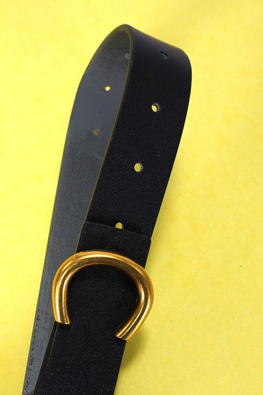 Black belt with a gold buckle on a yellow background