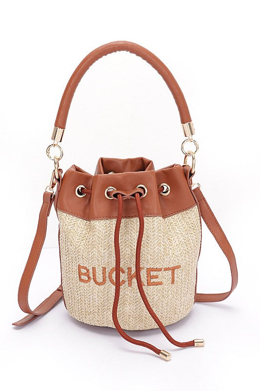 Bucket bag with brown leather accents and 'BUCKET' text on a white background