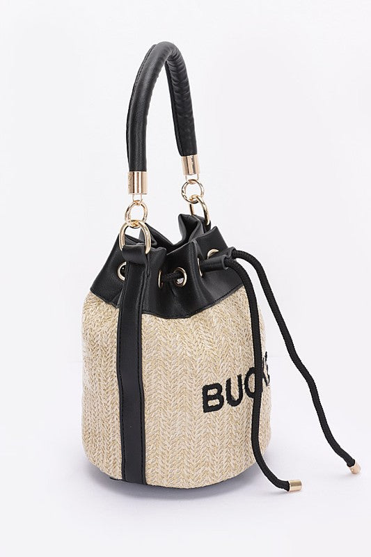 Straw handbag with black accents and visible branding on a white background