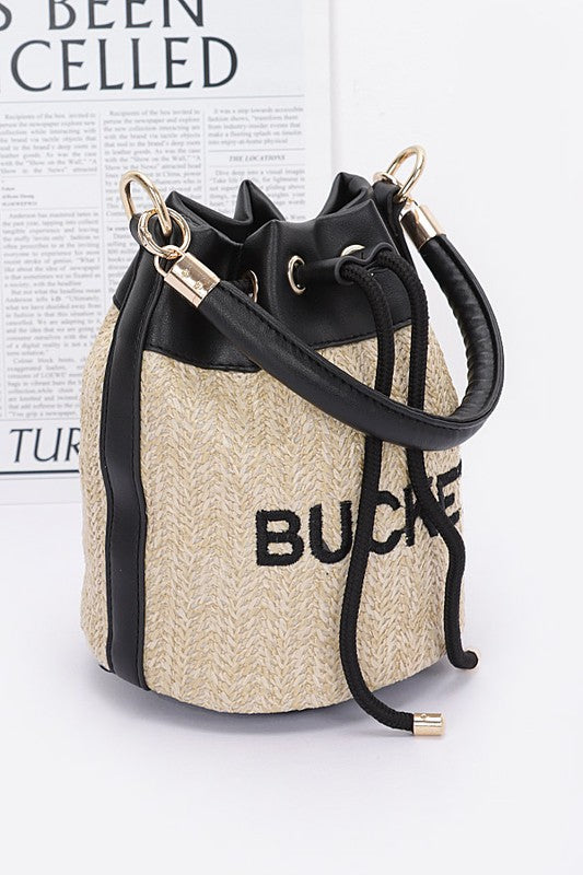Woven bucket bag with black drawstring on a white background