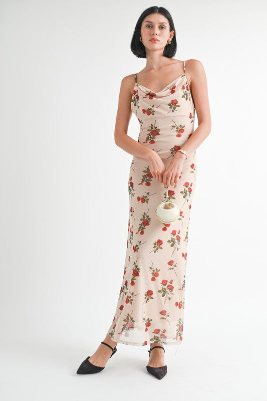 Woman wearing a floral dress holding a handbag on a white background