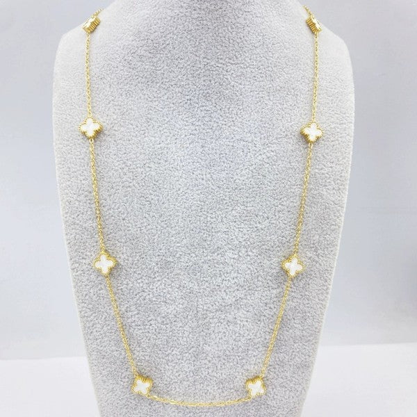 Gold necklace with star-shaped pendants on a gray stand