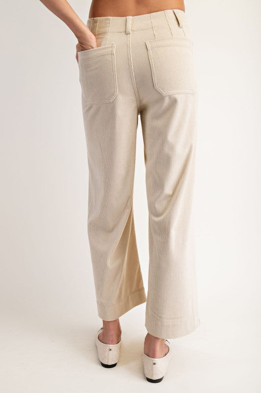 Beige pants worn by a person on a white background