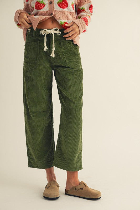Person wearing green pants with a white background