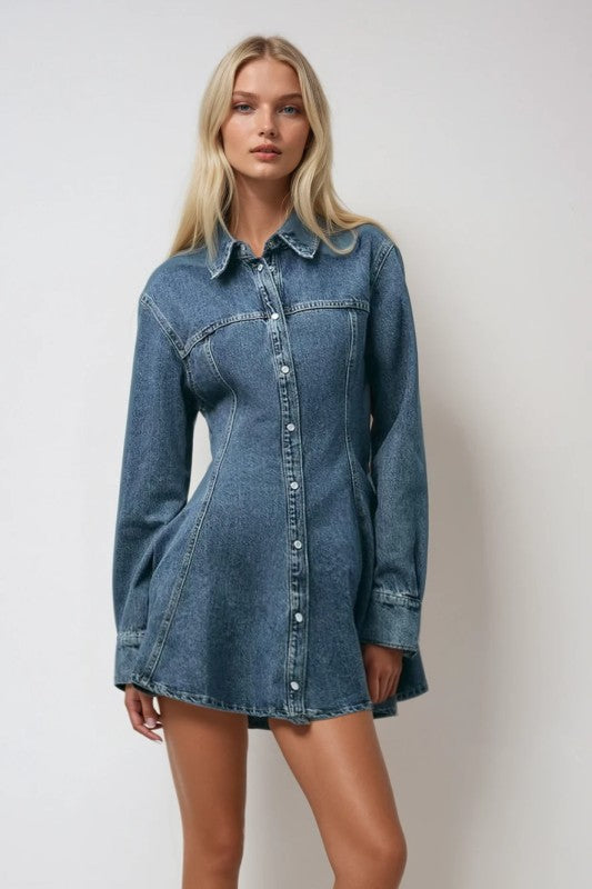 Woman wearing a denim dress against a plain background