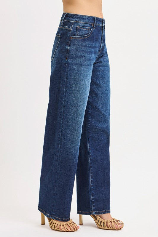 Blue jeans worn by a person on a white background