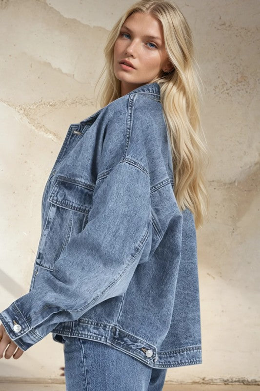 Woman wearing a denim jacket against a neutral background