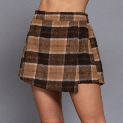 Plaid skirt worn by a person on a gray background