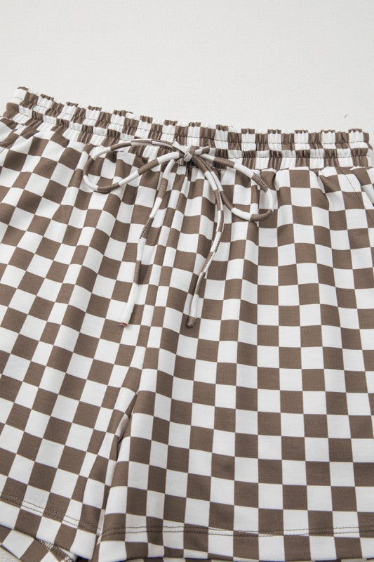 Checkered pants with brown and white pattern on a light gray background