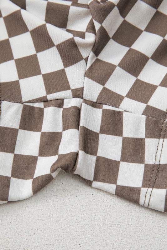 Close-up of brown and white checkered fabric on a light gray background