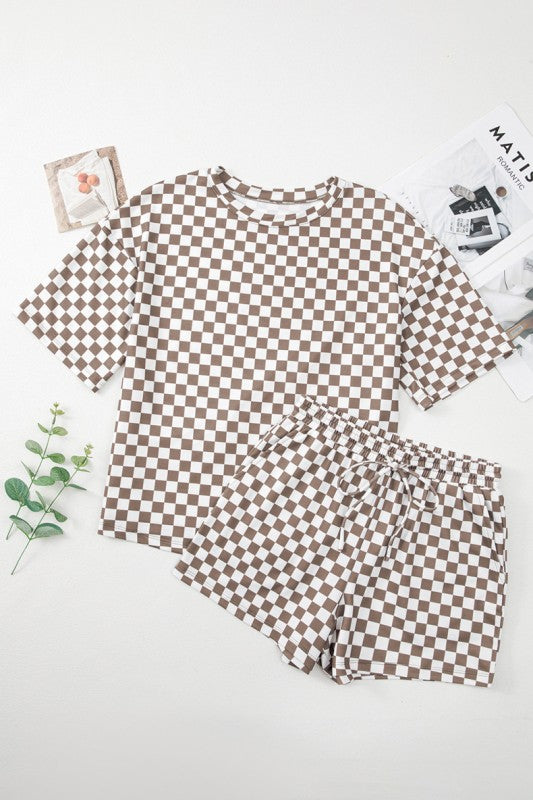 Checkered pajama set on a white surface with decorative elements.