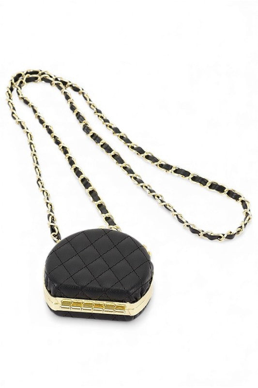 Black quilted handbag with gold chain on a white background
