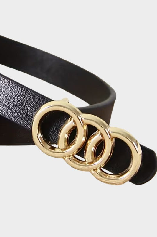 Black belt with a gold three-ring buckle on a white background
