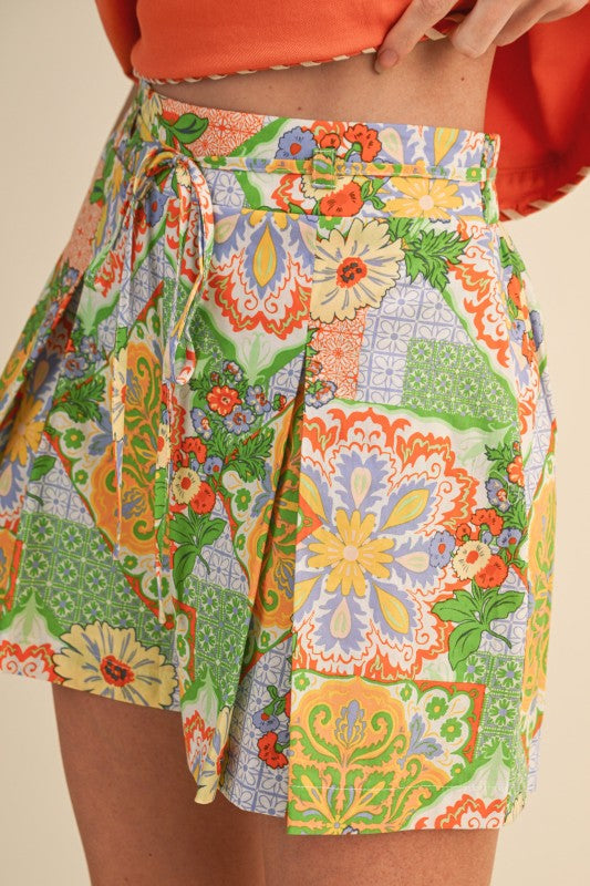 Colorful patterned skirt worn by a person on a beige background