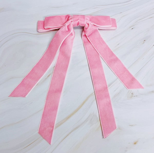 Pink velvet bow on a marble surface