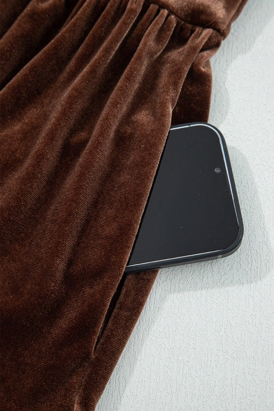 Smartphone on a white surface with brown fabric partially covering it