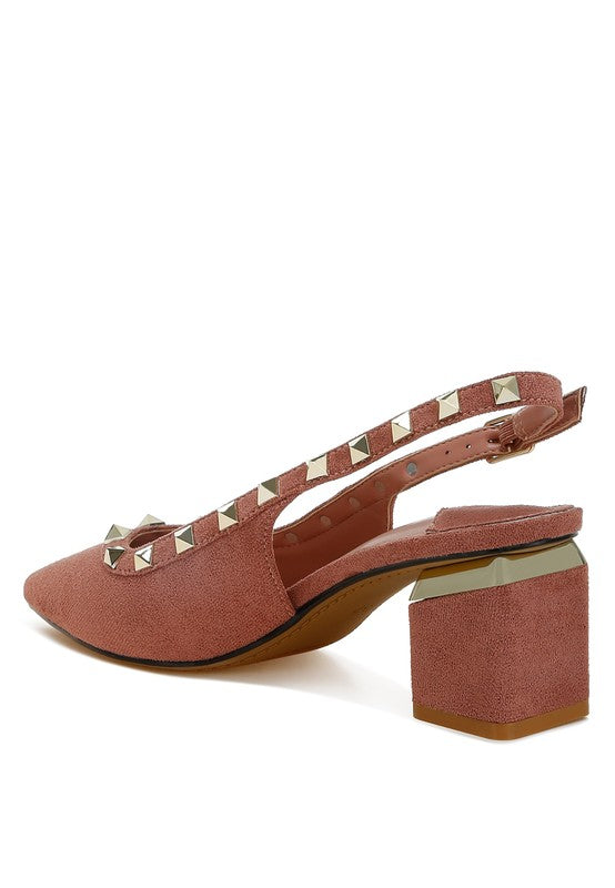 Pink high-heeled shoe with studded detail on a white background