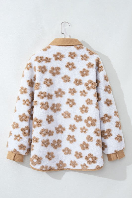 Floral-patterned jacket on a hanger against a white background