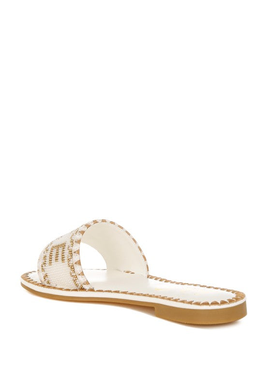White sandal with brown sole on a white background