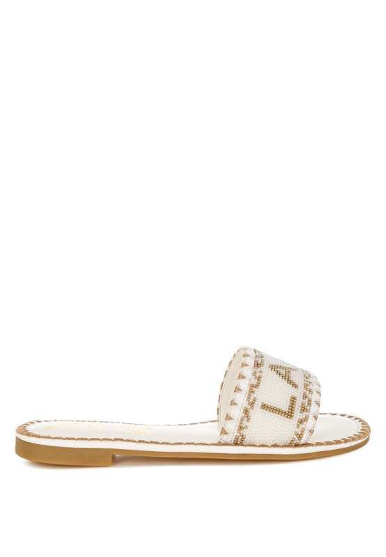 White sandal with brown sole on a white background