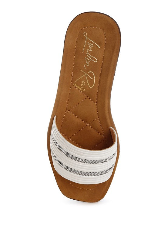 Brown sandal with white strap on a white background