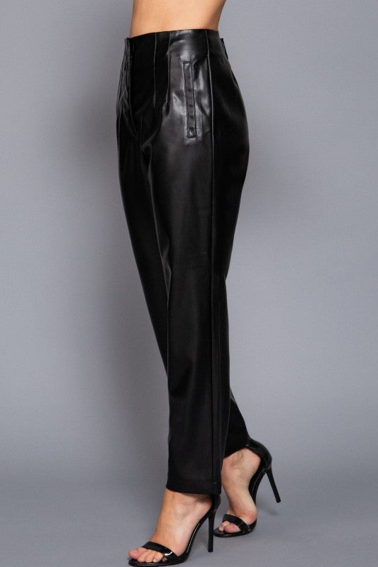Black leather pants with a high slit on a gray background