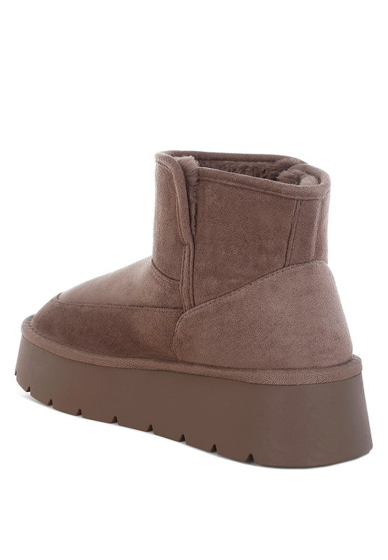 Brown suede platform boot on a white background