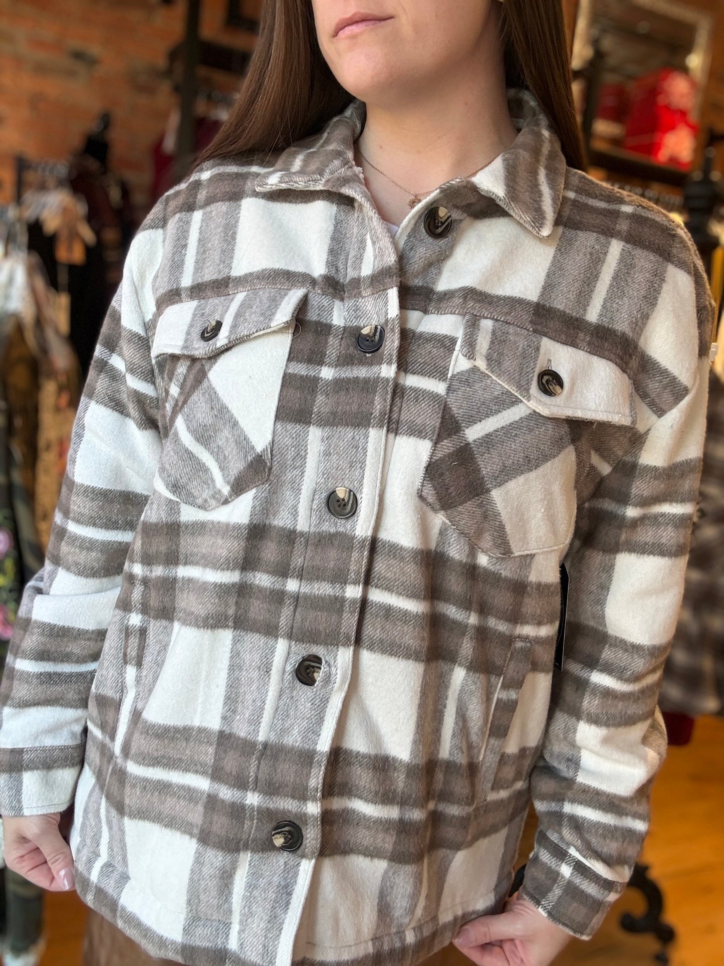 Person wearing a plaid shirt with a blurred background