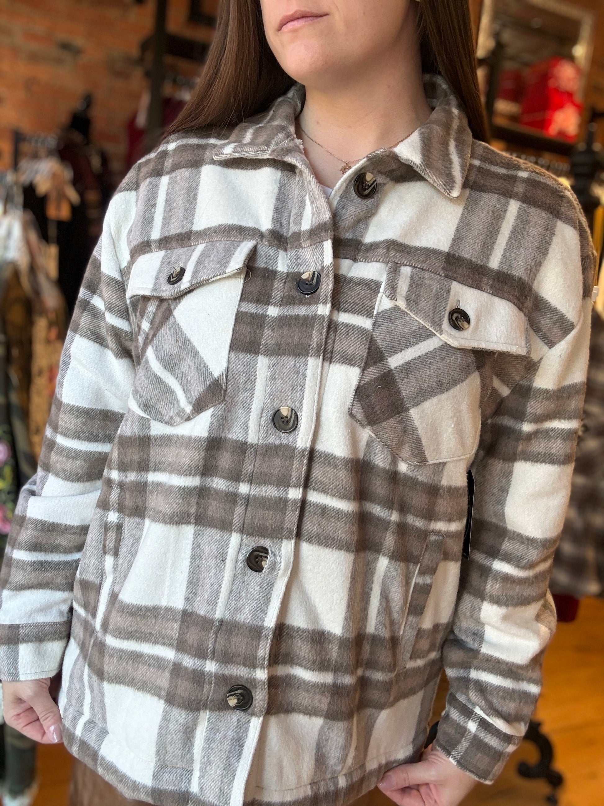 Person wearing a plaid shirt with a blurred background