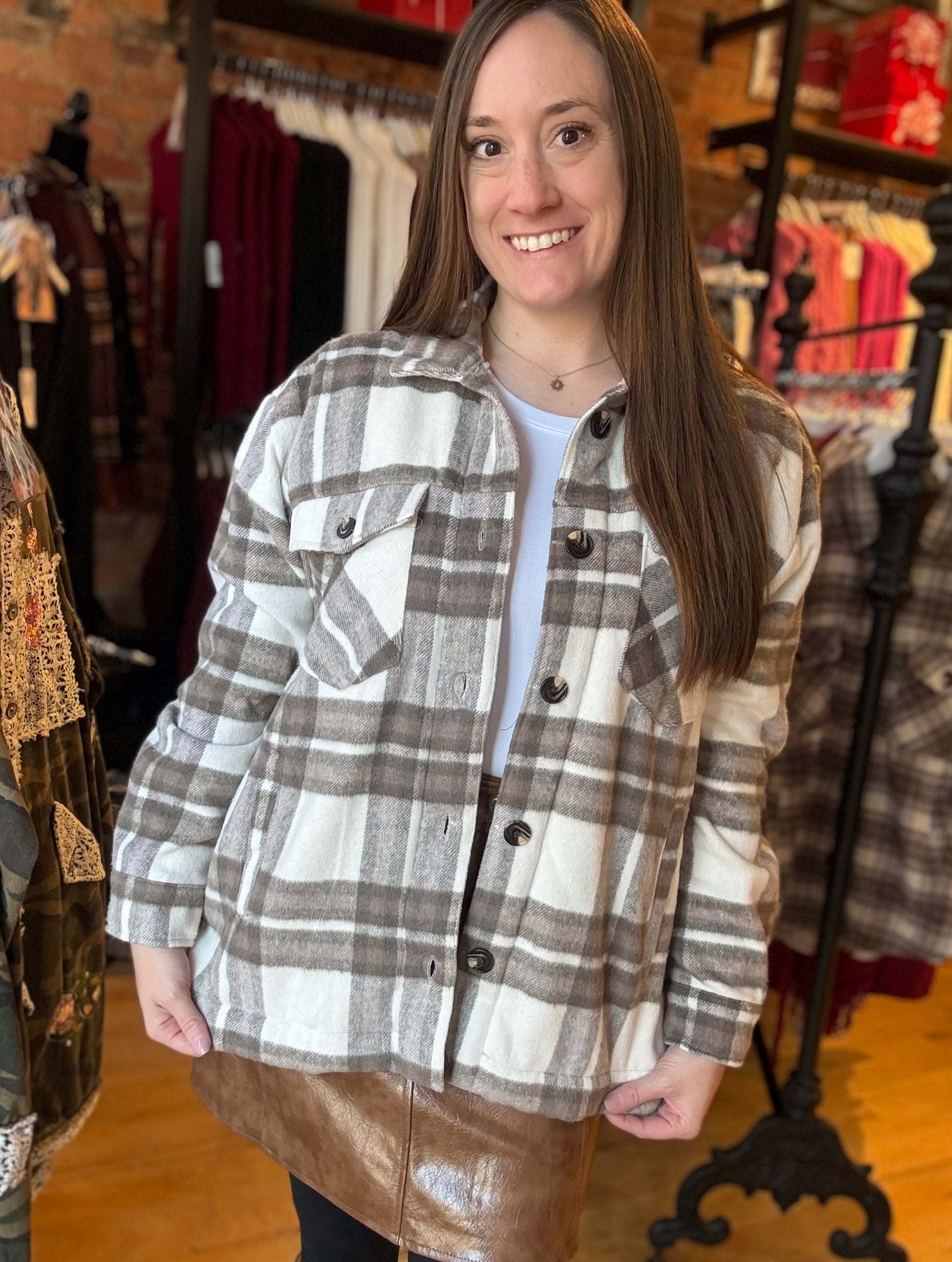 Woman wearing a plaid shirt in a clothing store