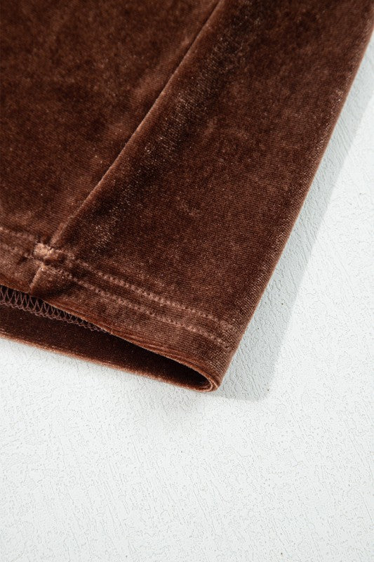 Close-up of brown velvet fabric on a white background