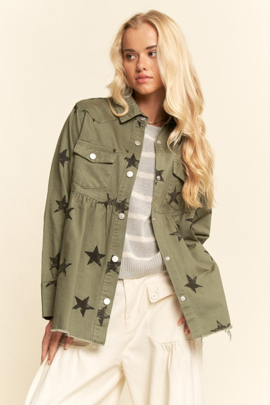 Woman wearing a green jacket with star patterns on a beige background