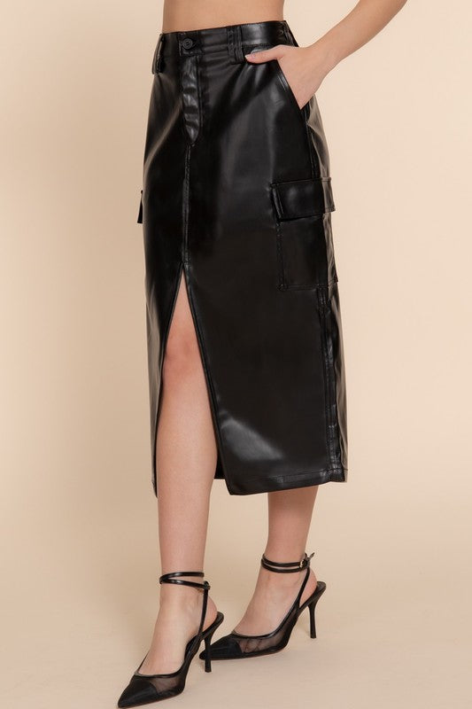 Black leather skirt worn by a person on a beige background