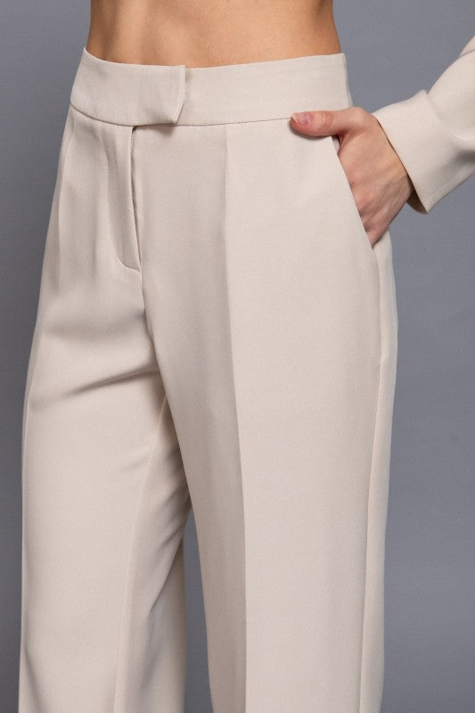 Beige pants worn by a person on a gray background