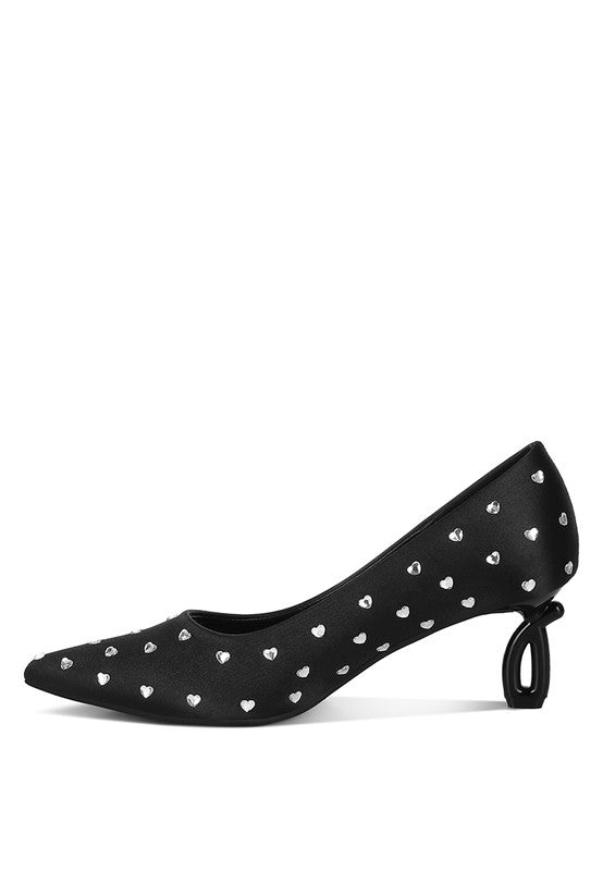 Black high-heeled shoe with heart-shaped studs on a white background