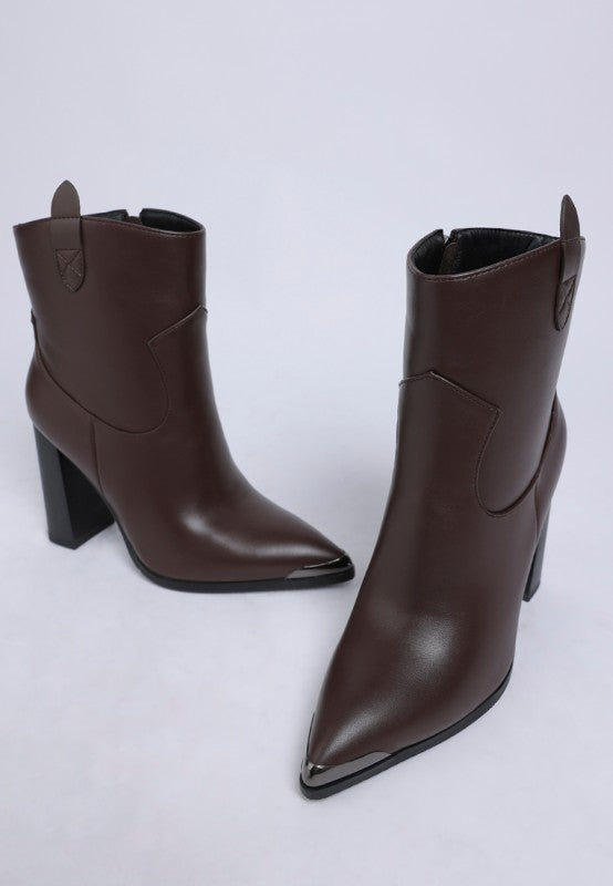 Pair of brown leather ankle boots on a light gray background