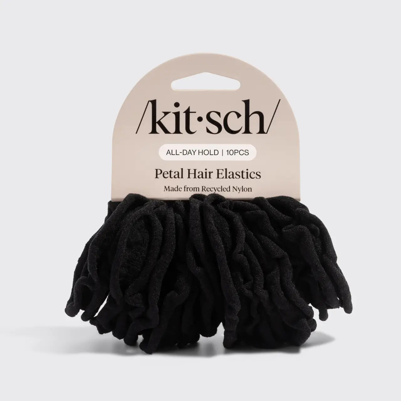 Black hair elastics with 'Akit'sch' packaging on a light gray background