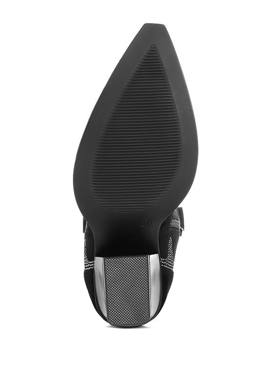 Black shoe with a textured sole on a white background