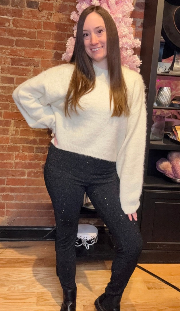 Black Sequin Leggings Paired with Black Boots and White Cropped Sweater Top