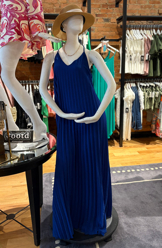Mannequin wearing a blue dress and straw hat in a clothing store setting