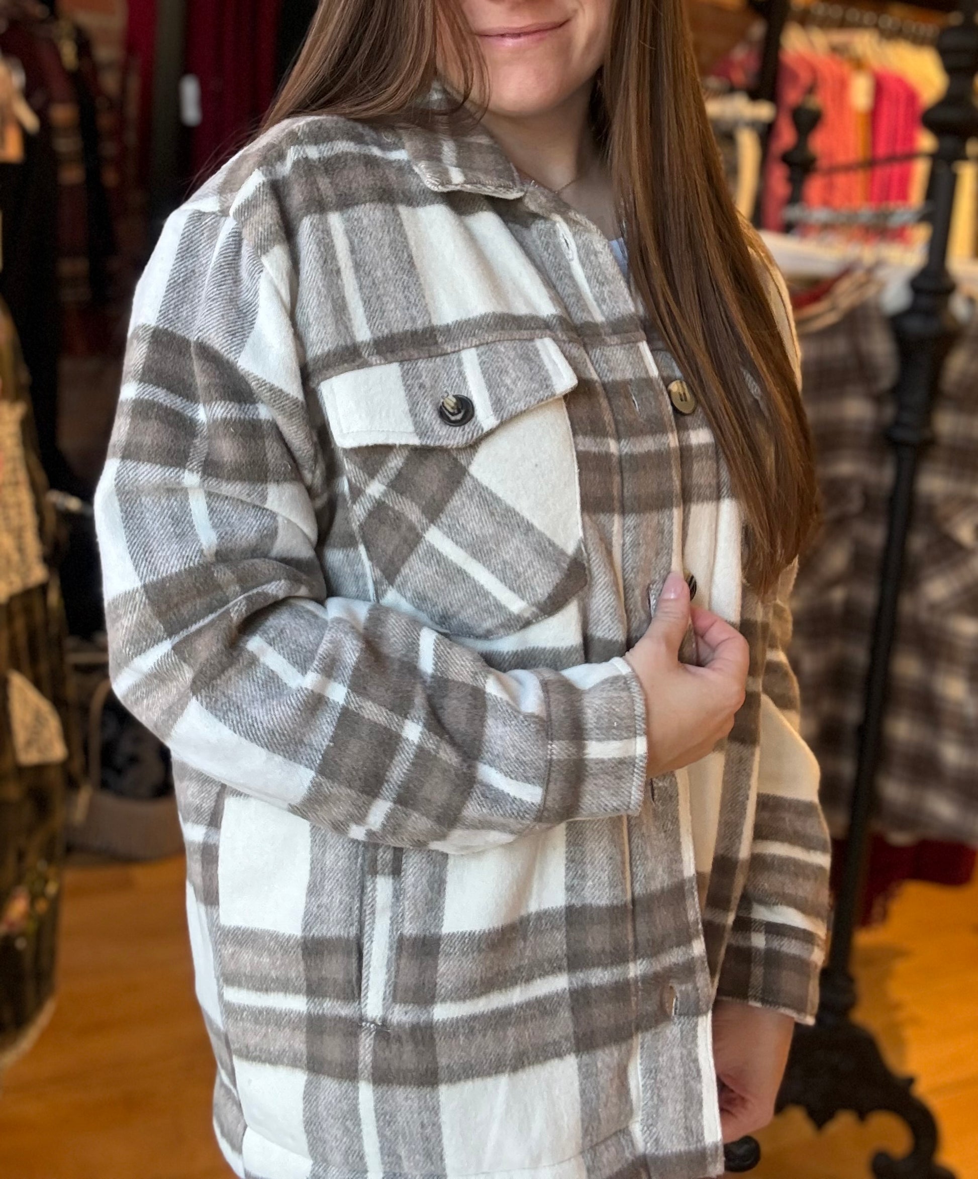 Person wearing a plaid shirt in a store setting