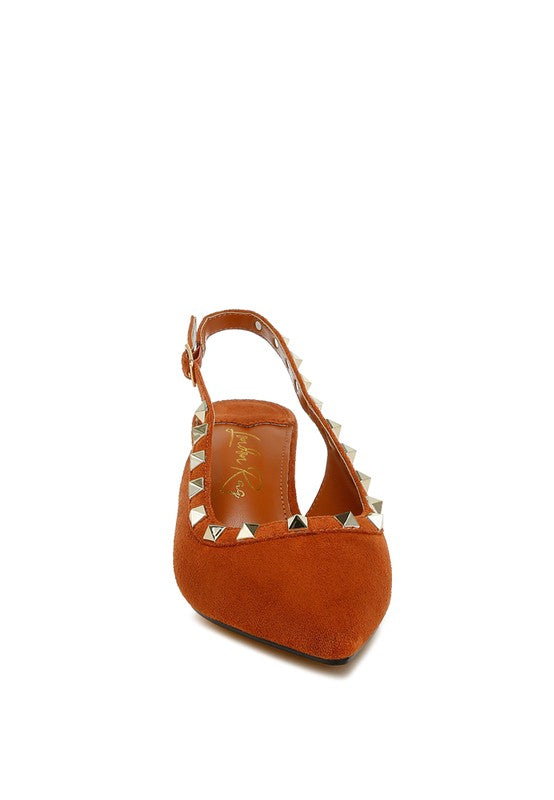 Orange sandal with studded details on a white background