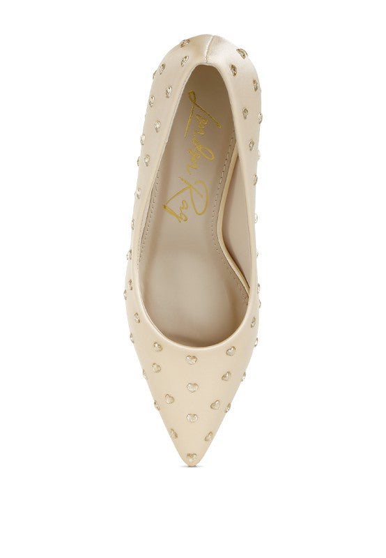 Beige studded high heel shoe on a white background