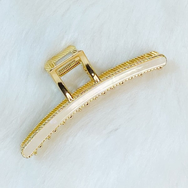 Gold hair clip on a white background