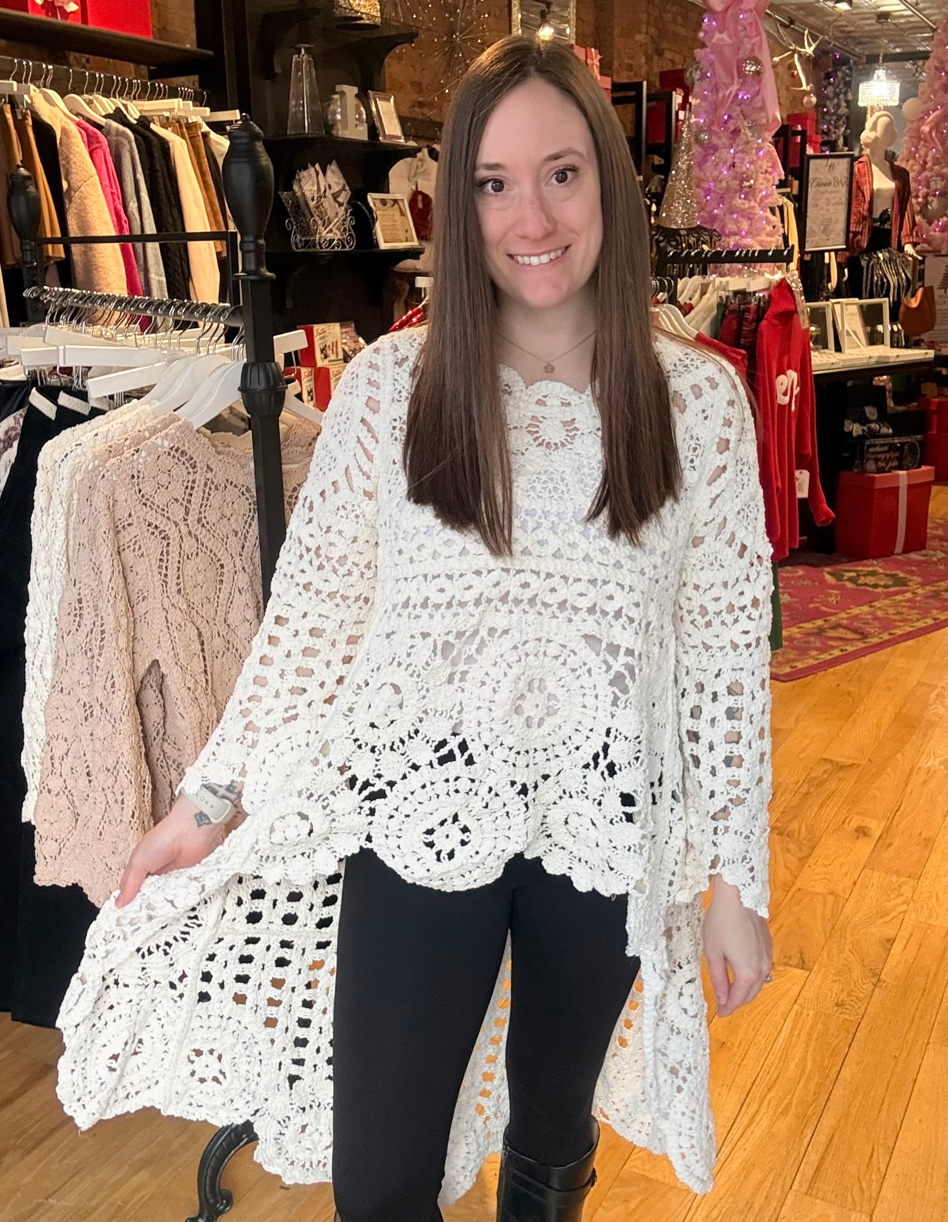 Woman wearing a white lace top in a clothing store
